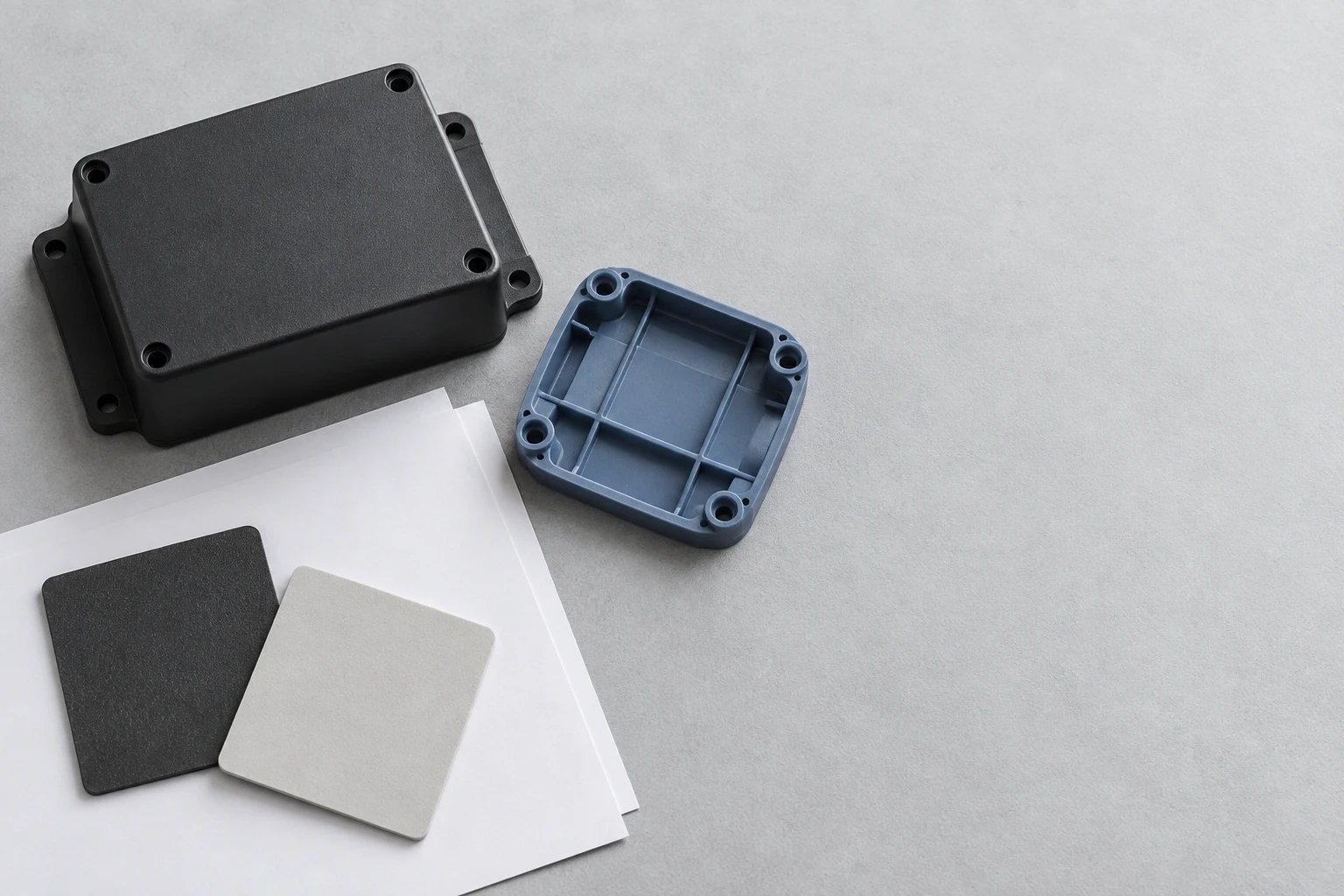 Conceptual flat lay of generic molded forms with blank sheets and neutral material swatches.